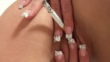 Chick puts cigarette in her pussy